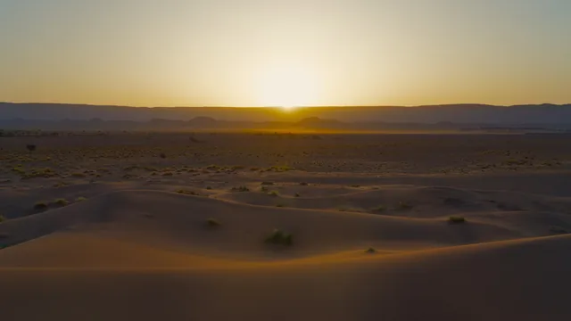 Sun rising over the sand dunes of the Sahara